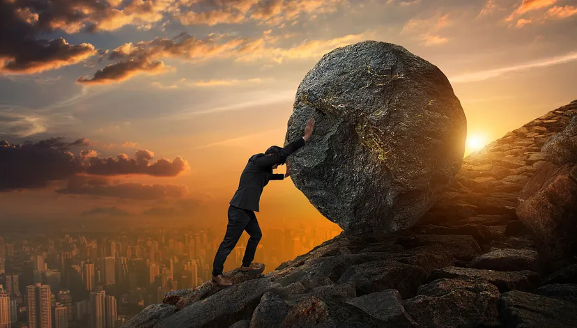 man pushing rock