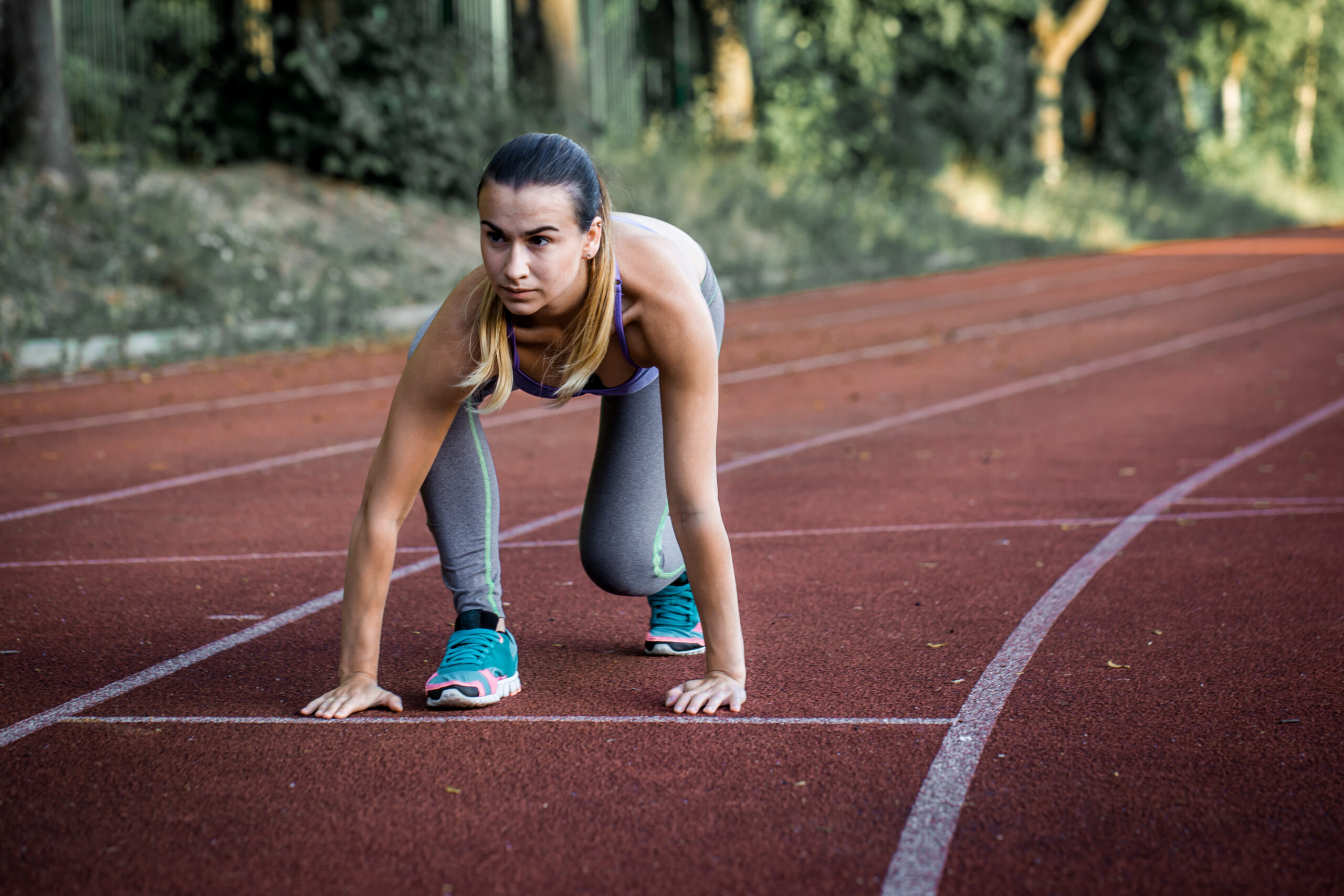 athletic girl on the start of track